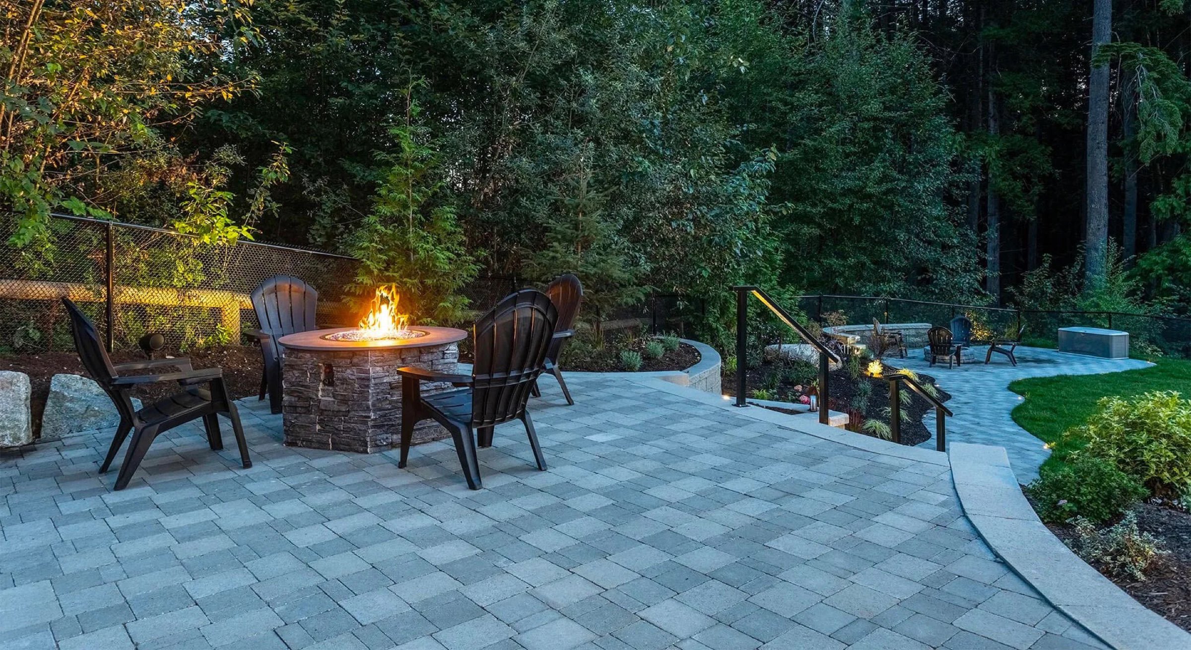 Outdoor living space with fire pit at dusk